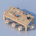 Wooden Long Table With Stump Style Chairs And Various Items On Top