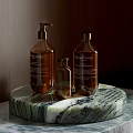 Natural Soap Bottles Display On Marble Countertop With Wooden Background