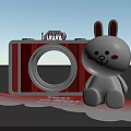 White Rabbit Doll Next To Red Camera Shaped Object With LOGO And Cloud Base 3d model