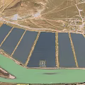 Aerial View Of Large Scale Solar Power Farm Along The Green Riverside Rural Mountainous Landscape