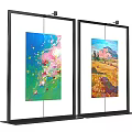 Two Black Frame Display Stands With Colorful Abstract And Landscape Paintings
