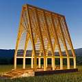 Illuminated Wooden House with Triangular Frame Open Design in Green Field Surrounded by Mountains