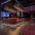 Modern Bar Interior Design With Sleek Counter Stools Neon Lighting And Bottle Displays