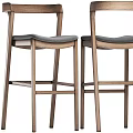 Modern Wooden Bar Stool With Gray Padded Seat And Tall Frame Design