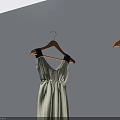 White Dresses With Black Decorations On Wooden Hangers Against Gray Walls And Floor With Reflections