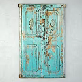 Vintage Blue Wooden Door With Distressed Paint And Carved Leaf Patterns