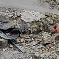 Pile of Construction Debris With Rubble Bricks Metal Sheets Yellow Blue Buckets And Dirt Path