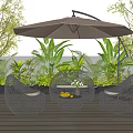 Woven Rattan Outdoor Sofa Set with Umbrella on Wooden Deck Surrounded by Green Plants
