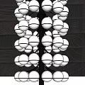 Elegant Contemporary Chandelier Featuring Multiple Circular Glass Lights Against Dark Wall
