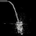 Garden Water Feature With Flowing Water Creating Ripples And Splashes Against Black Background