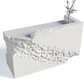 White Reception Desk With Textured Design And Small Plant On Top
