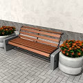Public Bench With Wooden Seat And Concrete Base Near Colorful Flower Pots On Paved Ground