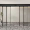 Modern Glass Door Entrance With Black Frame And Potted Plant On Gray Marble Floor