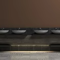 Stylish Bathroom Washbasin Design With Four White Bowls Dark Countertop And Patterned Floor Tiles