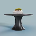 Stylish Black Round Table with Unique Pedestal Base and Decorative Books Small Plant
