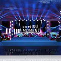Eye Catching Stage Design With Colorful Lights Large Screens And MOMENT Text Elements