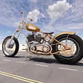 Custom Gold and Black Motorcycle on Road with Blue Sky White Clouds