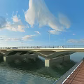 Concrete Bridge Over River With Street Lamps Pedestrian Walkway And Blue Sky White Clouds