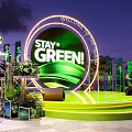 Green Themed Stage With Stay Green Sign And Plant Decorations At Night