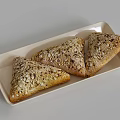 Triangular Whole Grain Bread With Oat Toppings On Light Rectangular Tray
