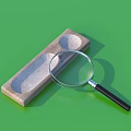 Wooden Rectangular Household Item With Two Circular Grooves And Magnifying Glass On Green Background