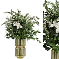 Decorative Potted Plant With Lush Green Foliage And White Flowers In Golden Vase