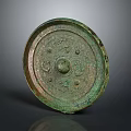 Ancient Bronze Mirror With Intricate Carvings And Circular Design Patina