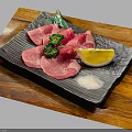 Sliced Raw Beef with Broccoli Lemon Slice and Salt on Black Plate Over Wooden Board
