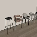 Various Design Bar Stools Arranged Against Light Colored Wall On Wooden Floor