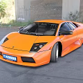 Orange Sports Car With Sleek Aerodynamic Design And Black Accents