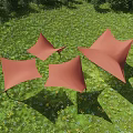 Red Tensile Membrane Structures In Green Meadow With Blue Sky And Trees