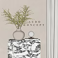 White Textured Vase With Green Branch Greenery On Marble Cabinet With Small Lamp