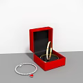 Open Red Jewelry Box Featuring Gold Ring And Pearl Necklace With Red Pendant