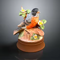 Ceramic Bird Figurine Featuring Black Head Orange Chest Green Leaves White Flowers And Brown Base