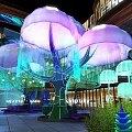 Jellyfish Shaped Floral Installation With Purple Pink Blooms Green Trees And Lighting In Mall Atrium