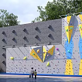 Colorful Climbing Wall In Happy Residential Community With Trees And Colorful Holds