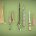 Various Decorative Knives with Diverse Blades and Handles on Green Background