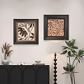 Framed Abstract Paintings With Floral Patterns On White Wall Near Black Cabinet And Green Plants