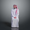 Man In Traditional White Robe With Pink Headscarf Sitting On Gray Background