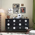 Black Console Cabinet With White Flower Patterns Decorative Vase Framed Art And Books On Top