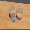 Three Clear Glass Jars With Granular Food Items Placed On Wooden Tabletop