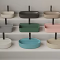 Various Colored Washbasins With Black Stands Neatly Arranged On Multi Tiered White Shelves