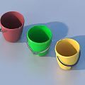 Three Colorful Buckets Red Green Yellow With Metal Handles On Light Blue Surface