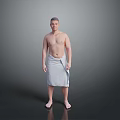 Shirtless Man Standing Wrapped in Gray Towel Against Gray Background Barefoot