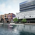 Commercial Landscape Featuring Modern Colorful Cube Buildings Along Waterfront River With Small Boats And Trees