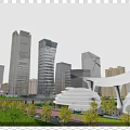 Modern Tall Office Buildings Featuring Glass Curtain Walls and Streamlined Design with Greenery and Roads
