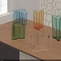 Colorful Geometric Glass Vases Arranged On Wooden Table With Window Blinds And Geometric Wall Art