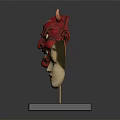 Red Demon And Light Colored Human Face Costume Masks On Black Base With Golden Stands