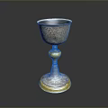 Artisan Crafted Silver Goblet With Intricate Carved Patterns And Golden Base