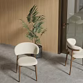 Modern White Dining Chairs With Wooden Legs Near Green Plant And Wooden Wall